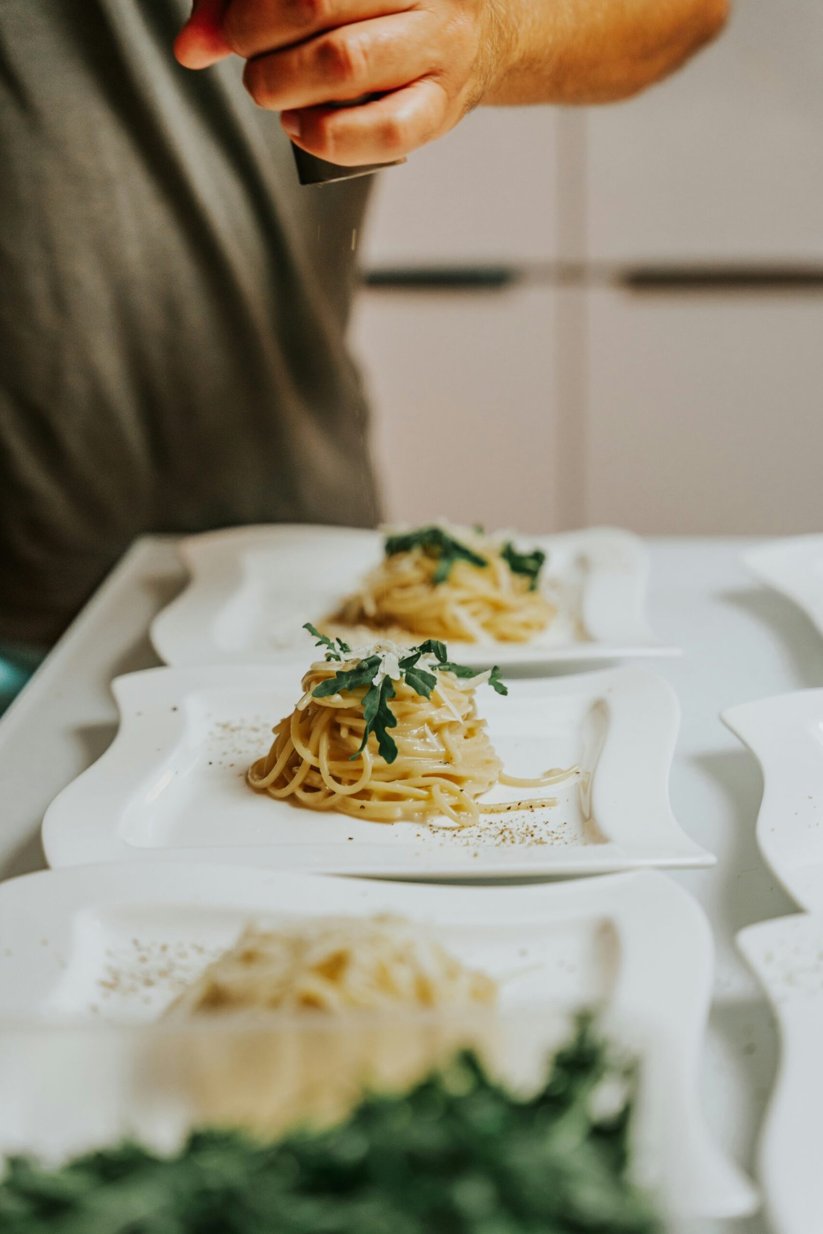 a person holding a knife over a plate of food